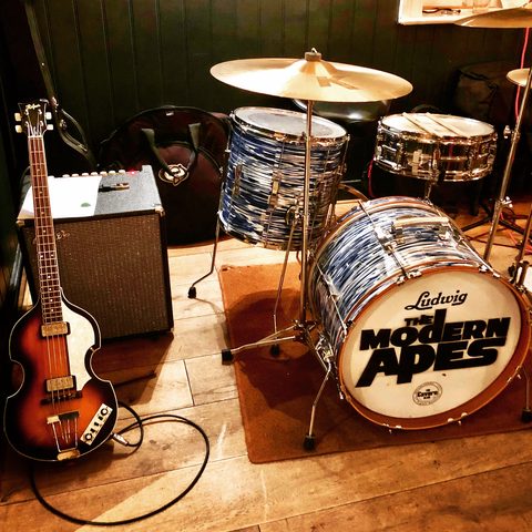 A Ludwig drum kit and a violin bass in a rehearsal room